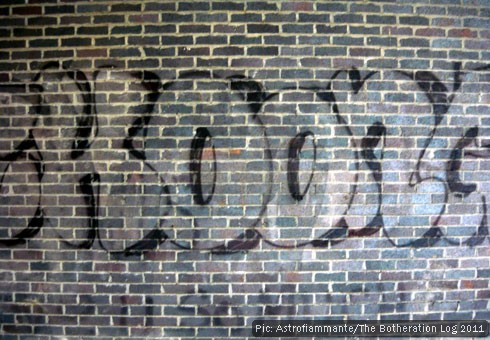 Large graffiti on the brick wall of an underpass