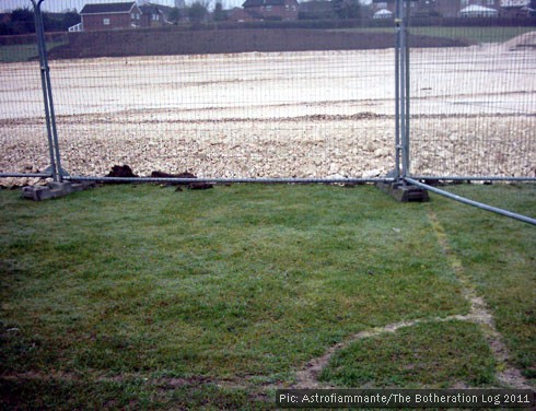 New all-weather sports pitch being laid on top of grass football pitch
