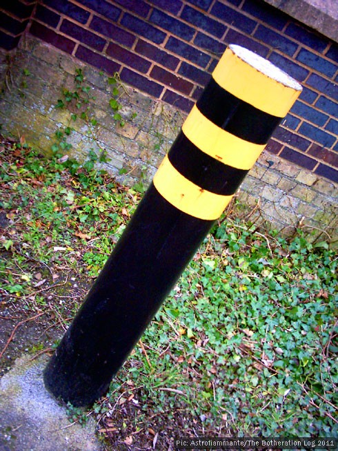 Post blocking vehicle access to a pedestrian path