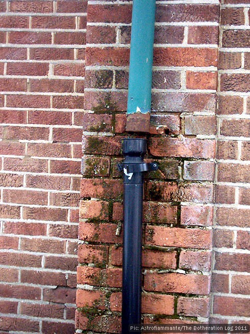 Disconnected drainpipe leaking onto brick wall