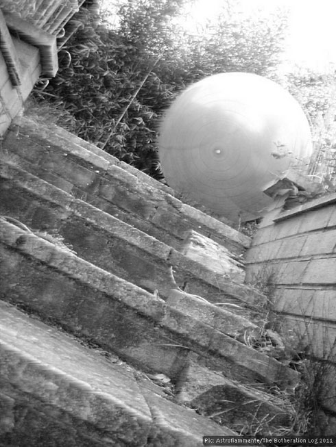 Large white ball descending a flight of steps