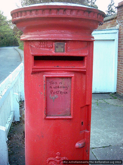 Red pillar box with message: 'This is a working post box'.