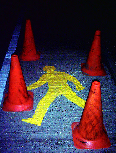 Painted pedestrian symbol surrounded by cones