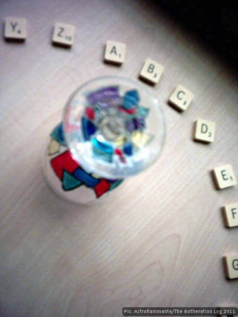 Wine glass in a circle of alphabetically-arranged Scrabble tiles