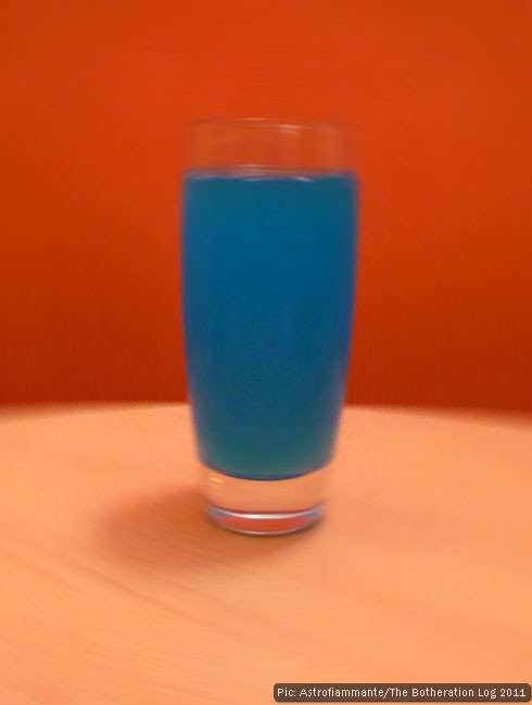 Blue energy drink pictured against an orange wall