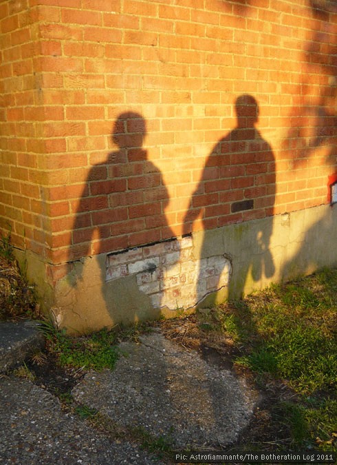 The shadows of two figures on a wall