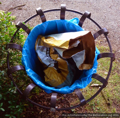 A discarded wrapper stuffed in a litter bin, seen from above