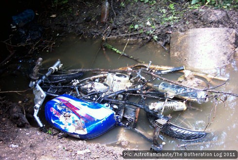 A wrecked motorbike in a culvert