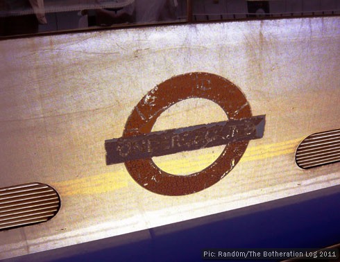 Faded London Underground symbol on the side of a train