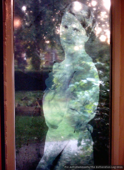 "Semi-transparent picture of a woman superimposed on a view of a garden"