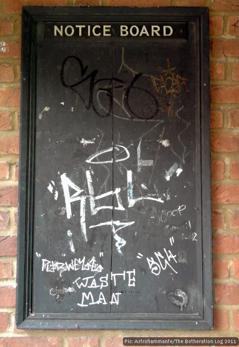 Village noticeboard with grafitti