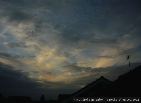 Sunset to the north over silhouetted rooves.