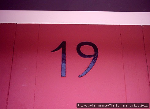 The number 19 on a pink painted background