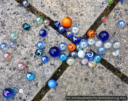 Glass marbles on paving stones Glass marbles on paving stones