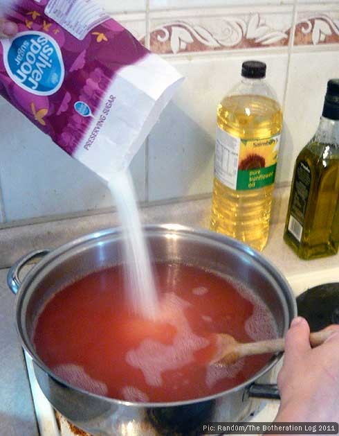 Preserving sugar being added to jam mixture