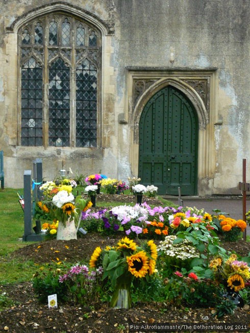 Church door and graves decorated with flowers