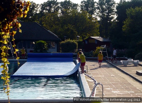 Cover being dragged across outdoor pool