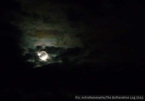 Night-time shot of moon emerging from clouds