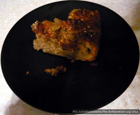 Slice of apple cake on a black plate