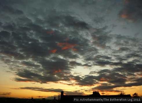 Picture of orange-gold and grey sunset over rooftops