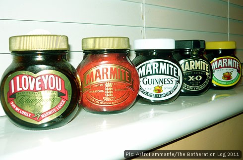 Five different jars of Marmite displayed on a windowsill