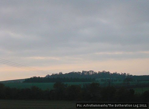 Wooded hill pictured at dusk
