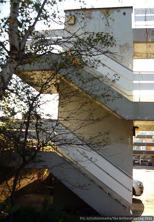 Concrete steps with parallel handrails winding around a central pillar