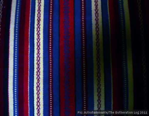 Vertical red, white and blue stripes on a woven rug