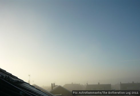 Rooftops seen through mist on a frozen morning