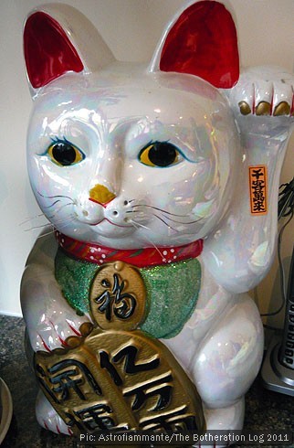 Chinese lucky cat with raised paw