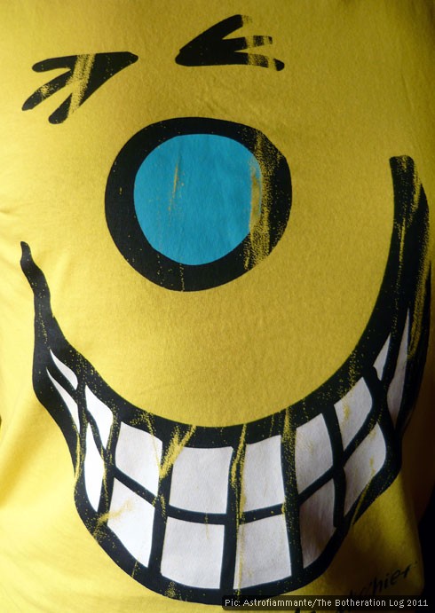 Yellow T-shirt depicting smiling cartoon face