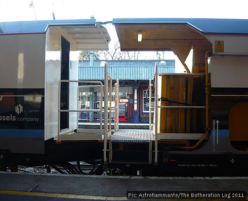 Two freight locomotives, joined back to back, waiting at station platform