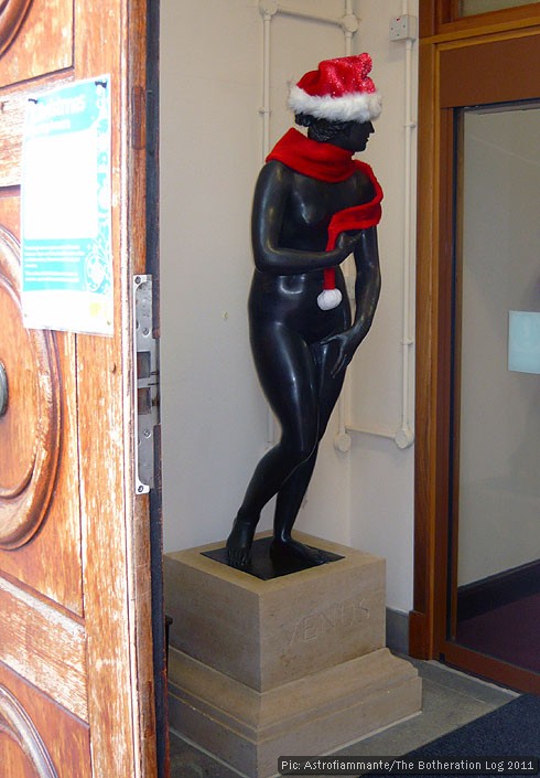 Bronze statue of Venus complete with Christmas hat and scarf