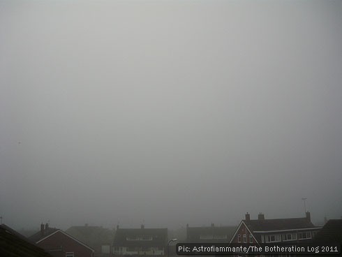 Foggy grey sky above rooftops