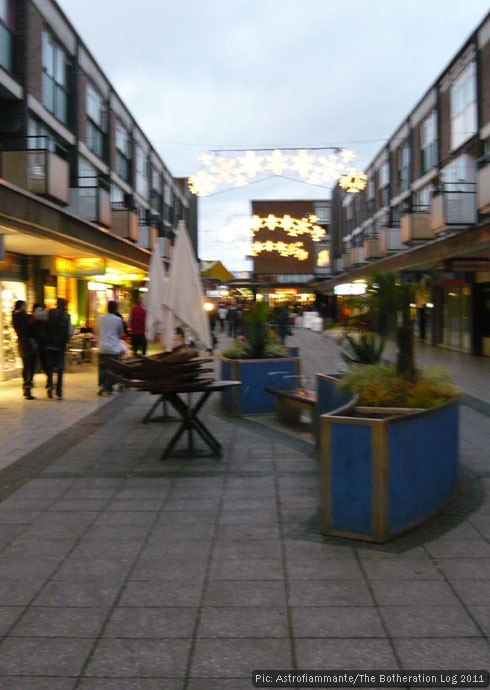 Town street in fading light with Christmas decorations overhead