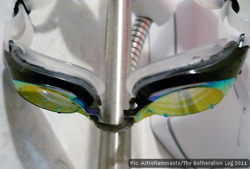Pair of protective swimming goggles hanging up to dry
