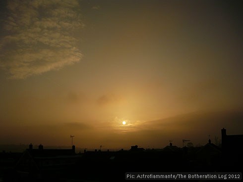 Gold and bronze sunset in a misty sky