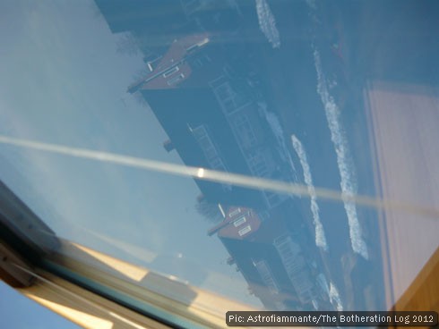 Snowy street reflected in skylight window