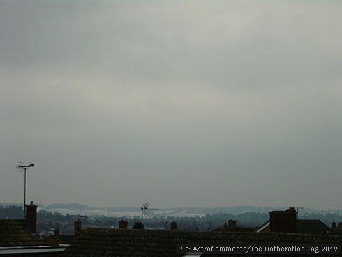 Heavy cloud and snowy hills on the horizon