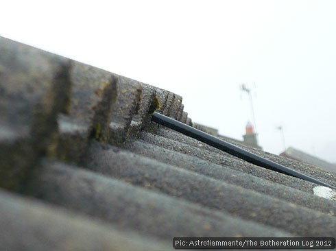 Roof tiles against white cloud