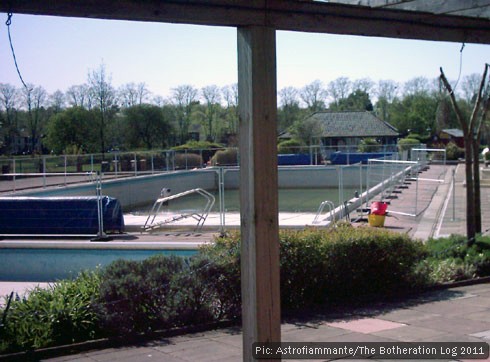 Open air pool being emptied for pre-season cleaning.