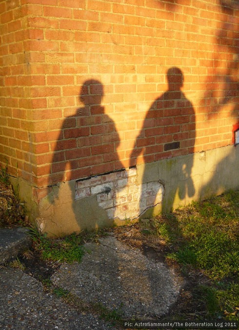 The shadows of two figures on a wall