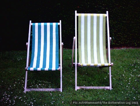 Two deckchairs side by side in a garden