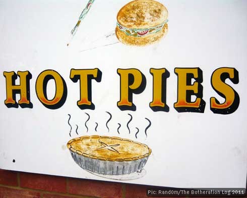 Painted sign outside shop advertising hot pies