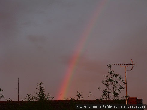 Late-evening rainbow over rooftops