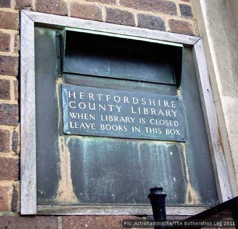 Former county library book-posting box set into brick wall