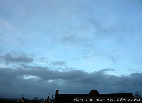 Low grey cloud against a vivid blue sky